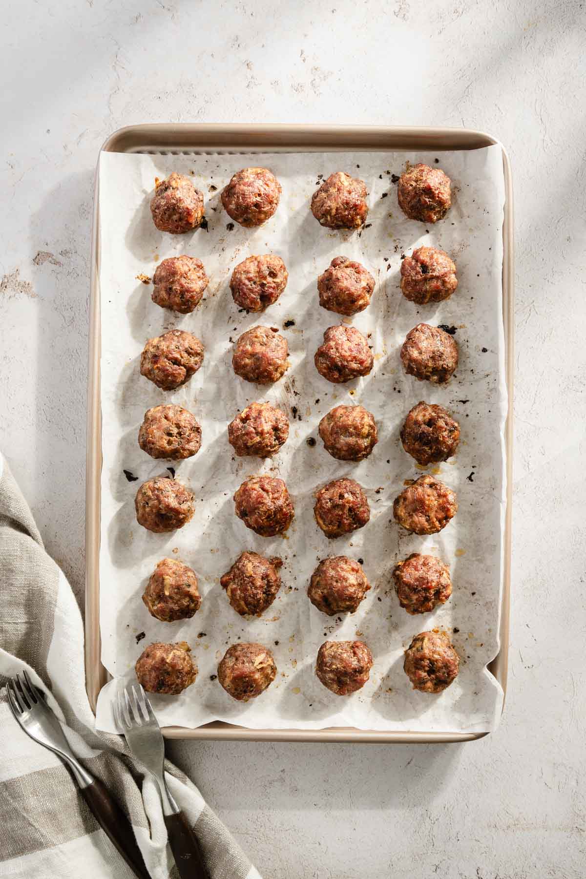 cooked meatballs on a baking sheet