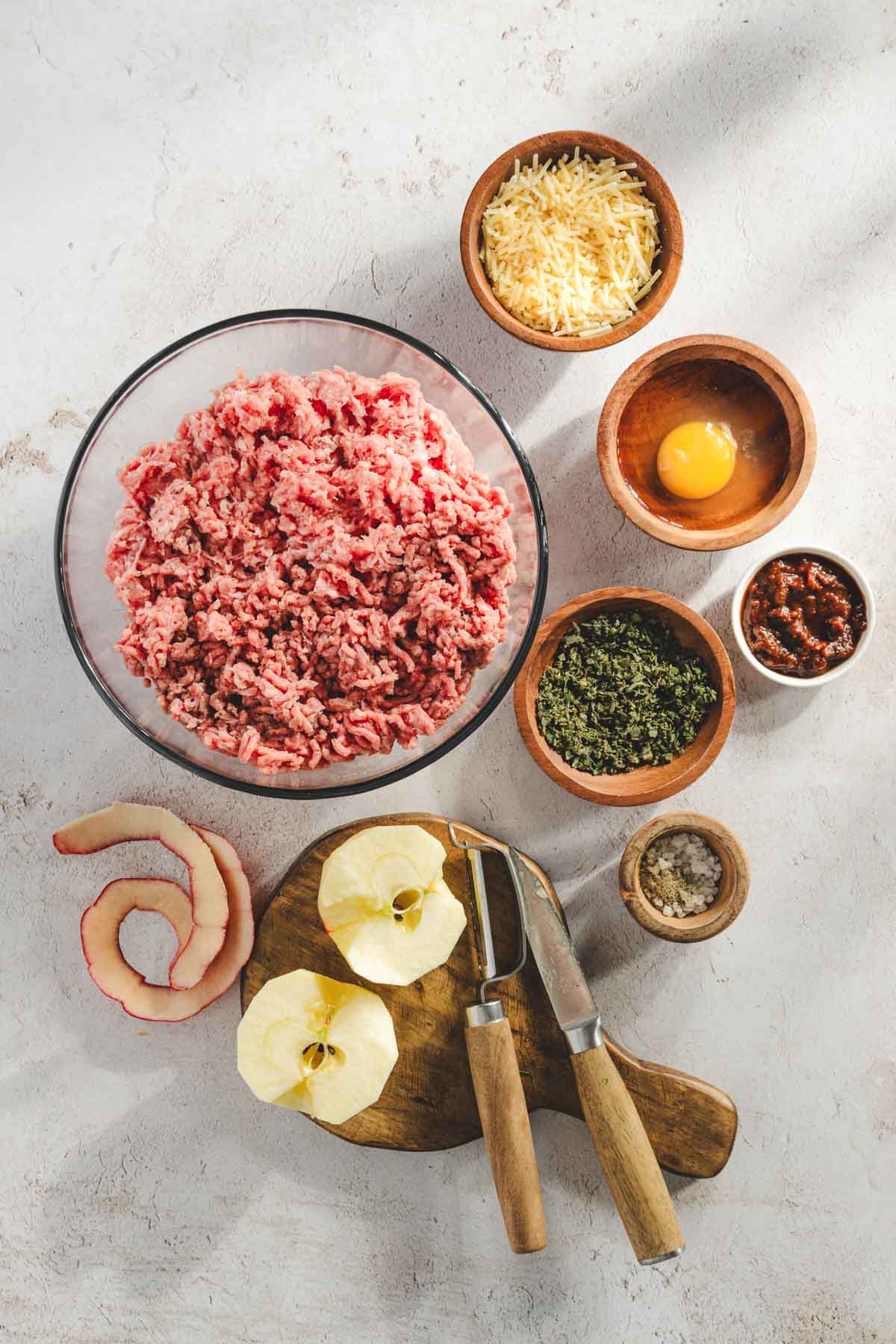 ingredients for apple sage meatballs, apples peeled and cut in half