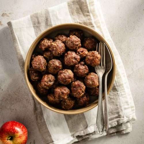 apple sage meatballs cooked and styled on a plate