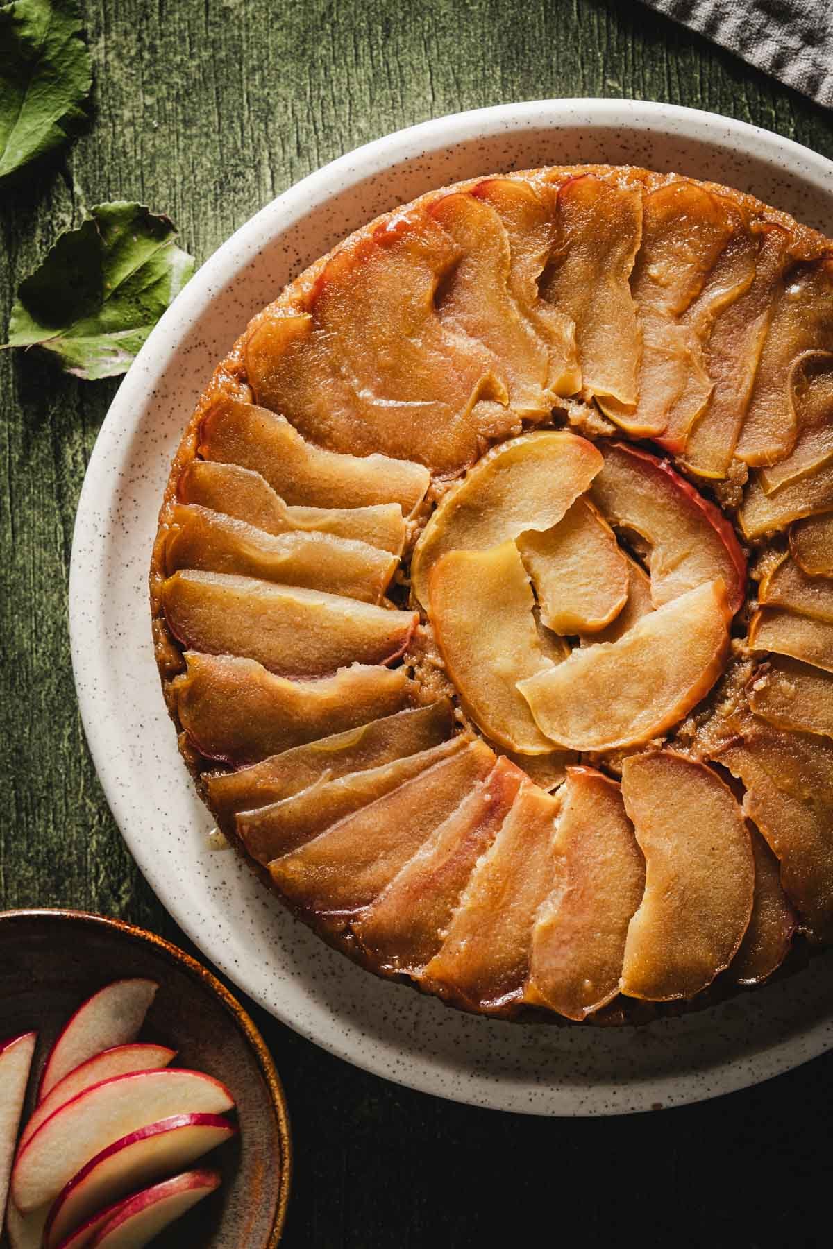 Overhead close-up of the caramelized apple spiral on top of an apple upside down cake.