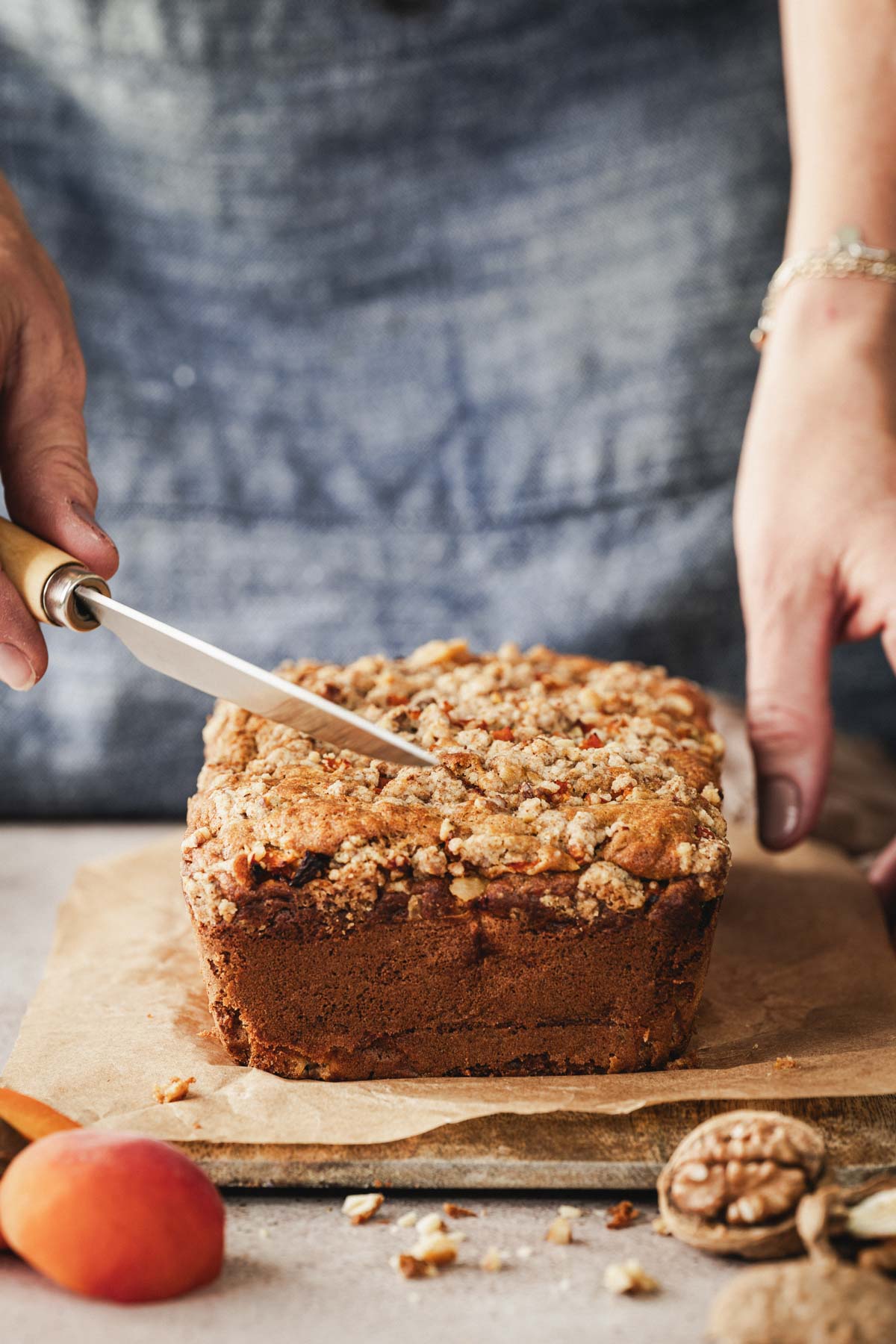 hands in frame holding knife to cut the bread