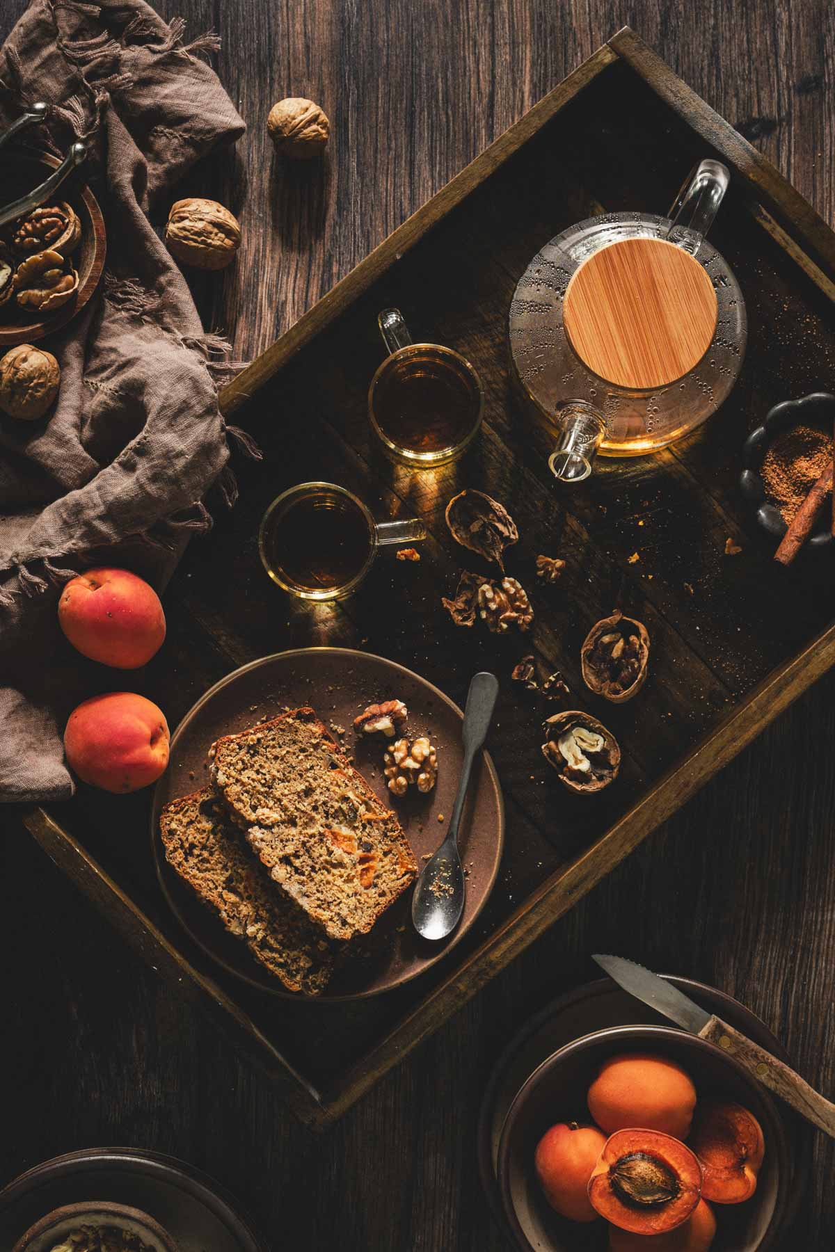 wooden tray with plate, tea cups and fresh apricots