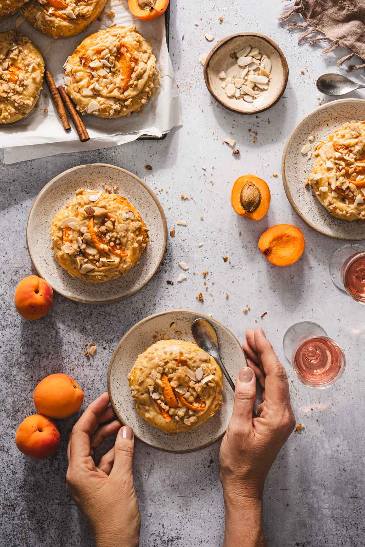various plates with sweet buns, hands in frame