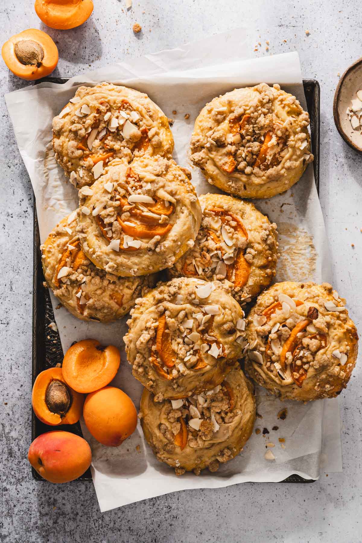 sweet buns on a baking sheet, fresh apricots