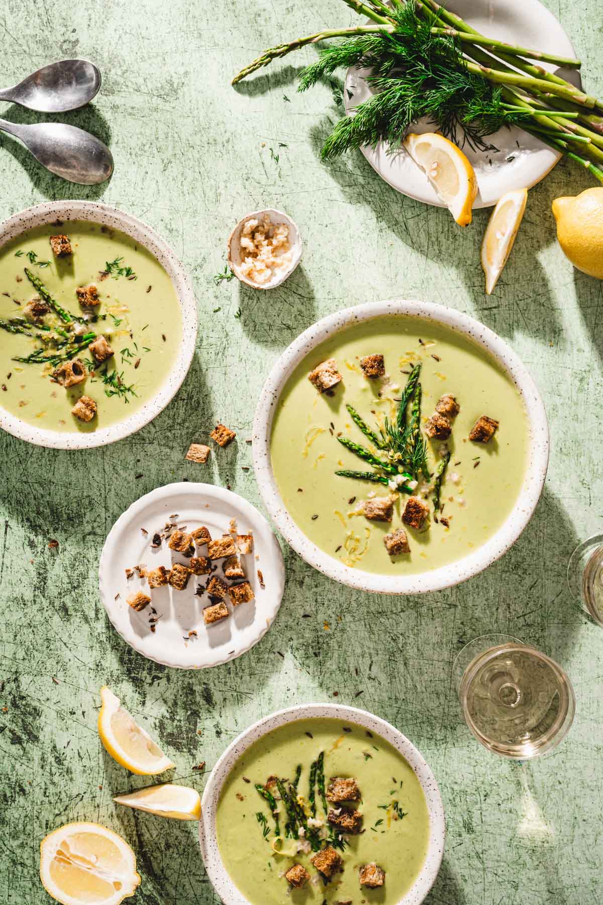 various serving bowls with souo, spoons, lemon wedges