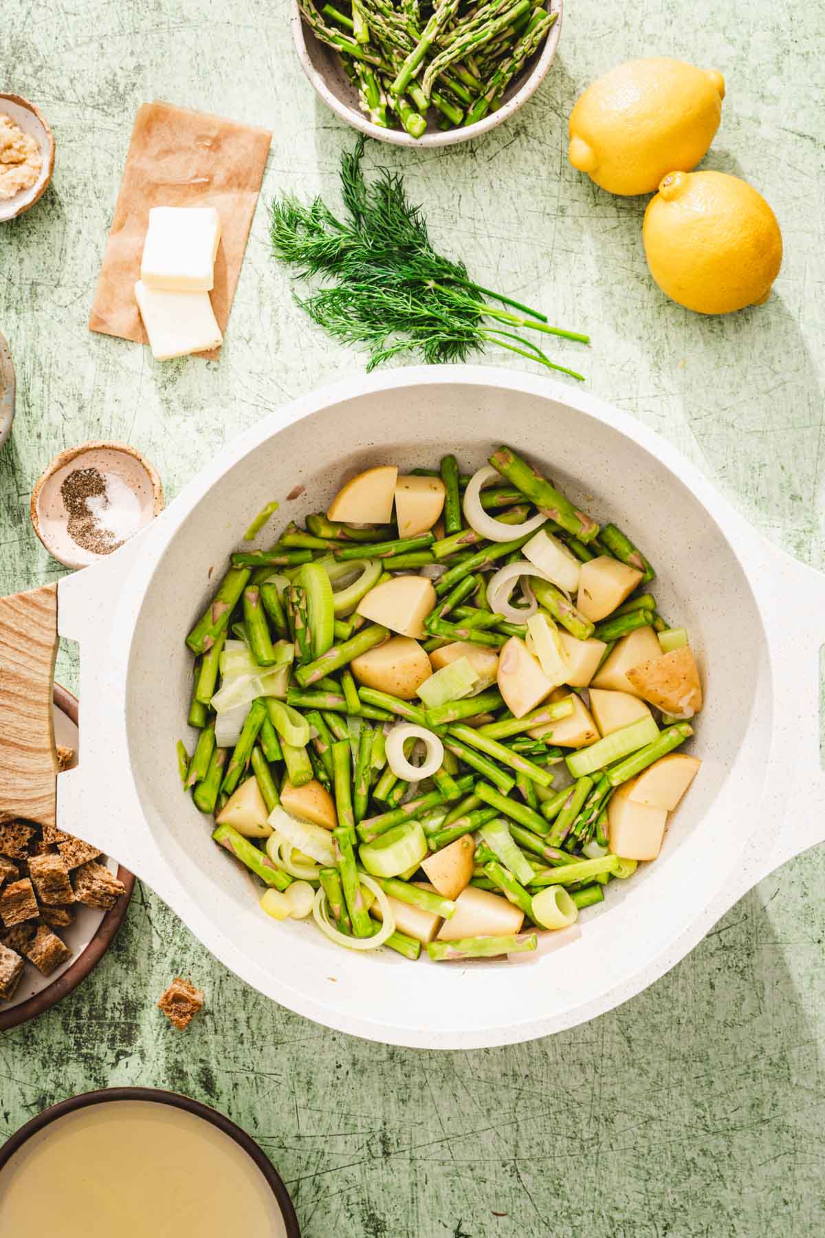 soup pot with chopped asparagus, potatoes, shallots and leeks