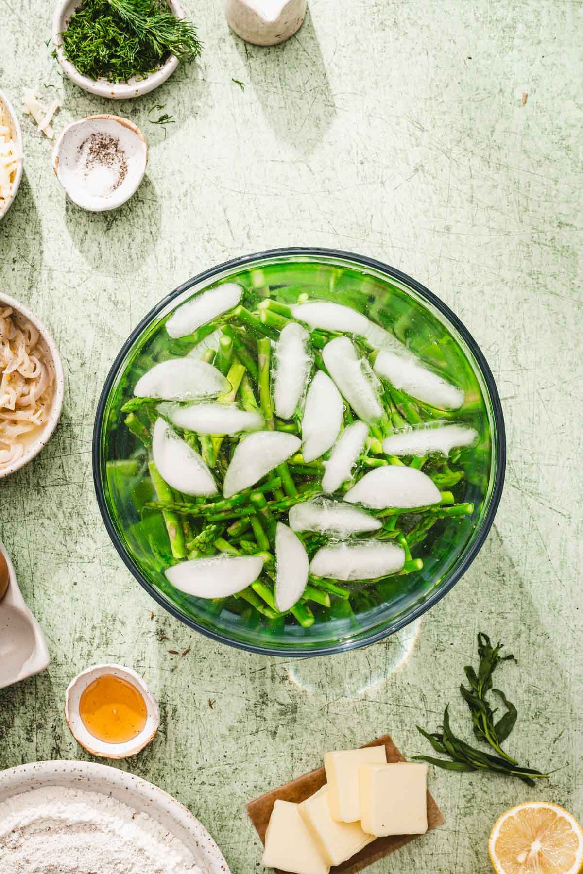 large bowl with icewater and asparagus