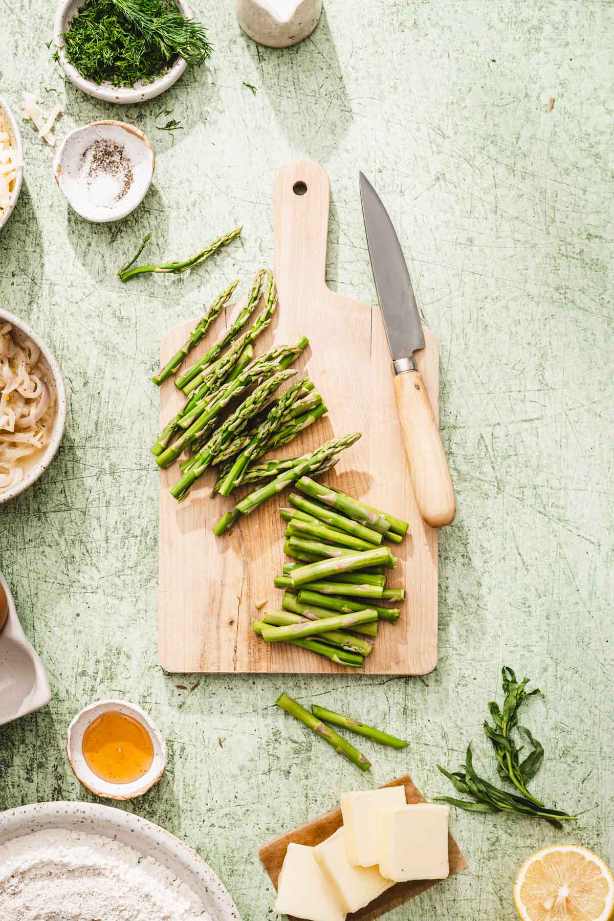 cutting board with cut up asparagus