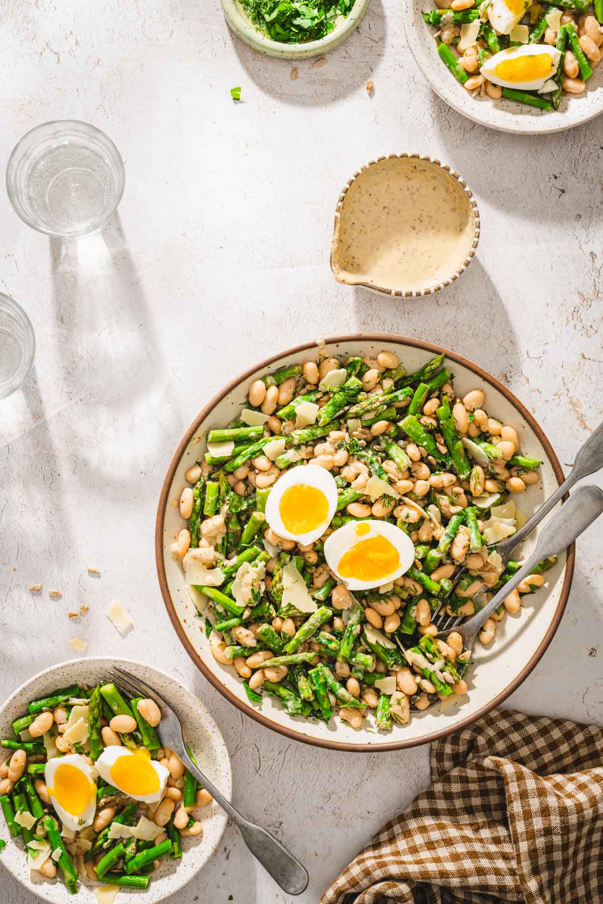 serving bowl with asparagus salad, dish with the dressing
