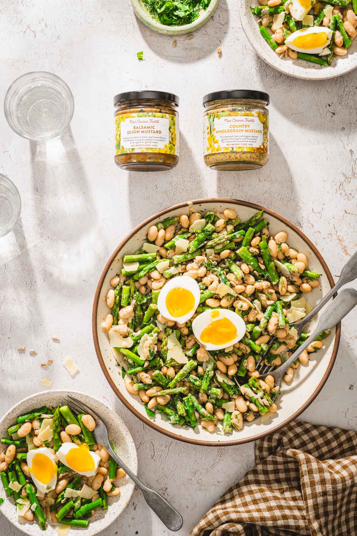 large bowl with the salad, brand jars, glasses with water
