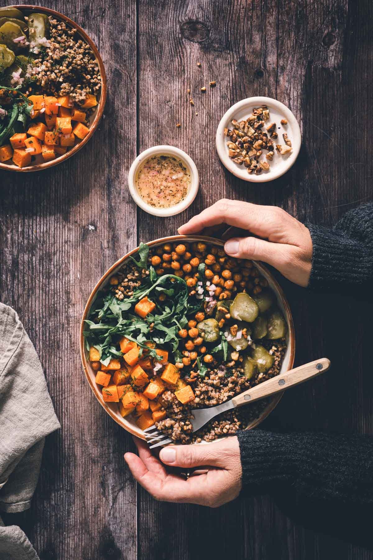 hands in frame holding buckwheat squash bowl