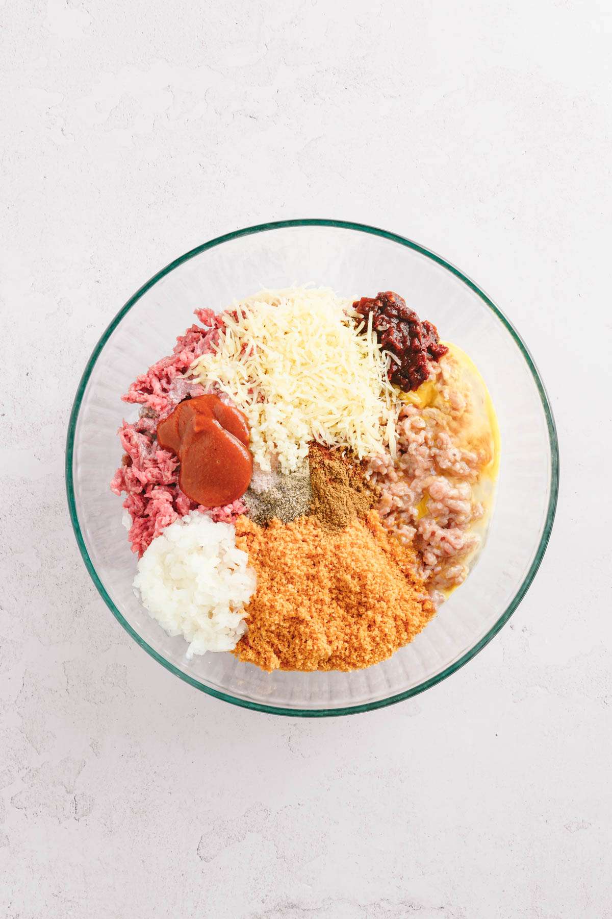 ingredients for bbq meatballs in a glass bowl