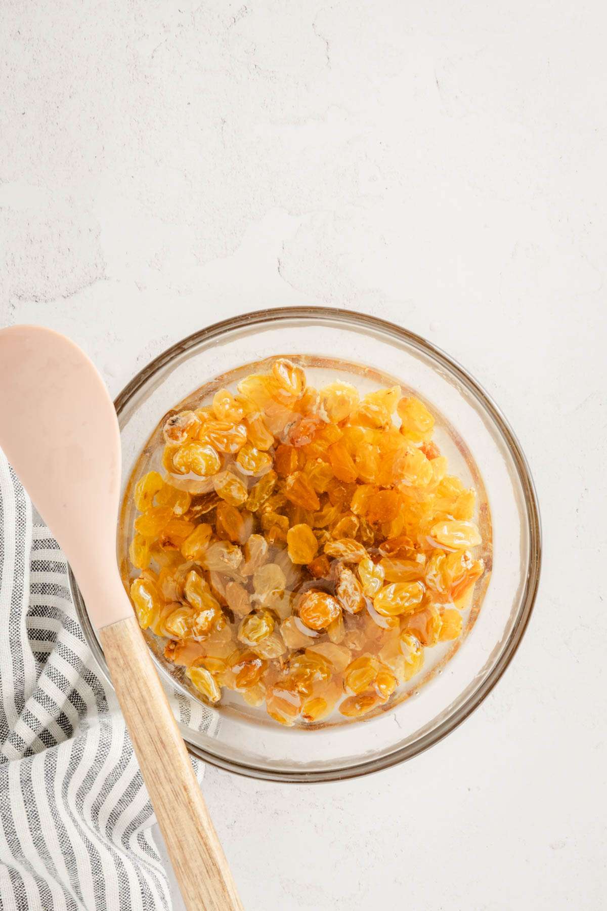 raisins in a glass bowl soaking in water