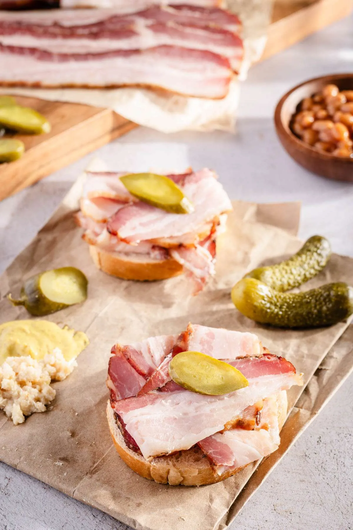sliders with slices of bacon and pickles
