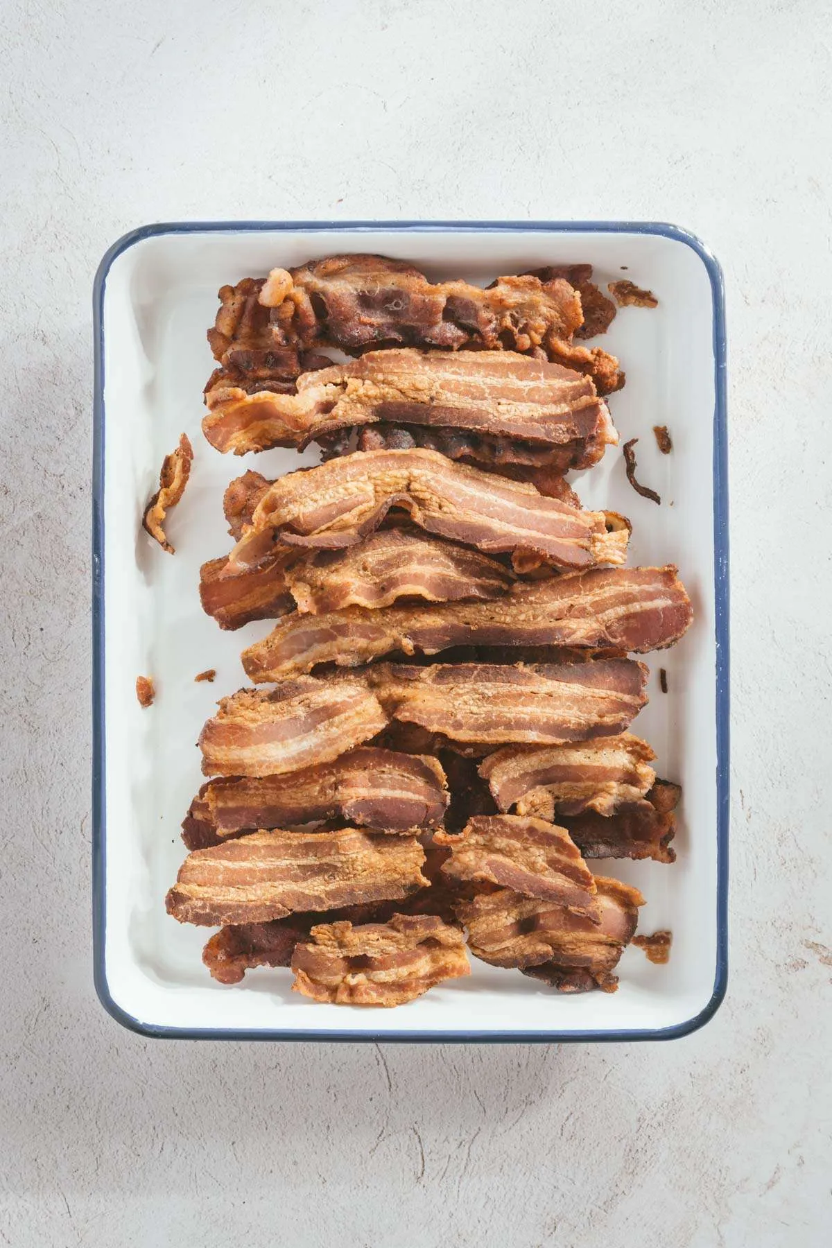 cooked bacon slices on a baking tray