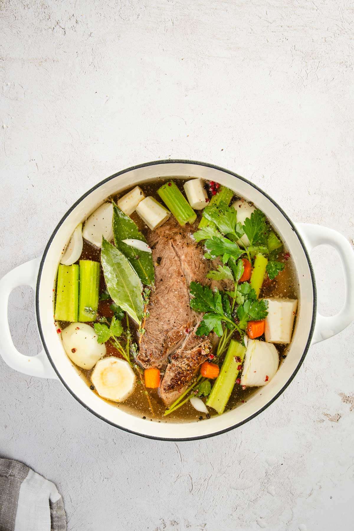 ingredients for beef broth in a cooking pot