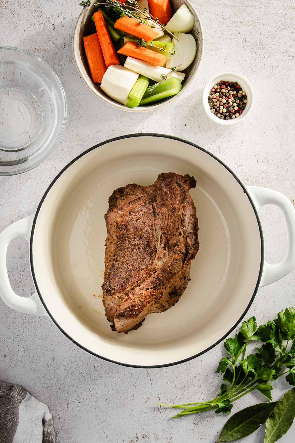 beef chuck in a soup pot, other ingredients for the broth around