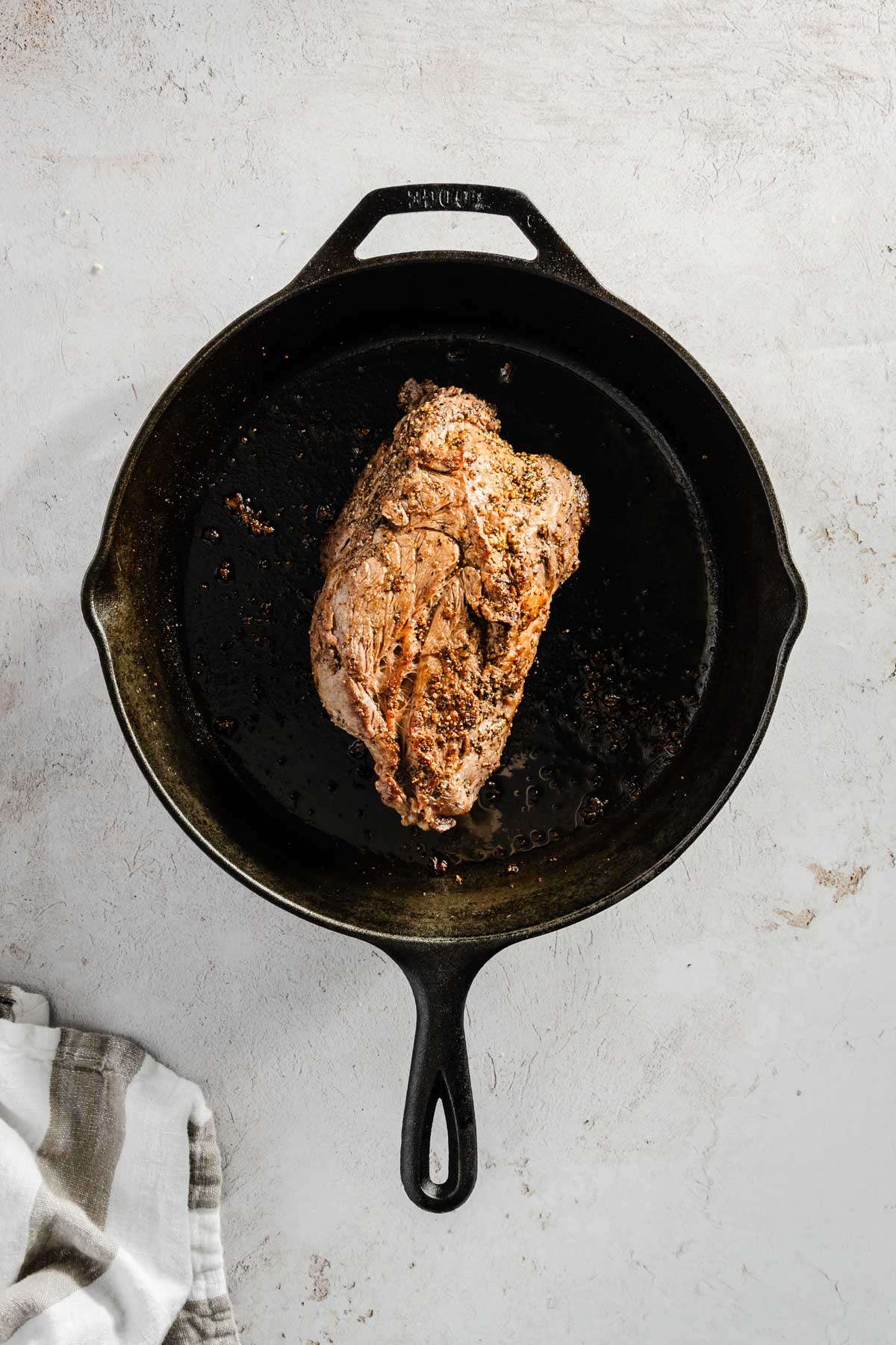 seared beef chuck on a cast iron pan