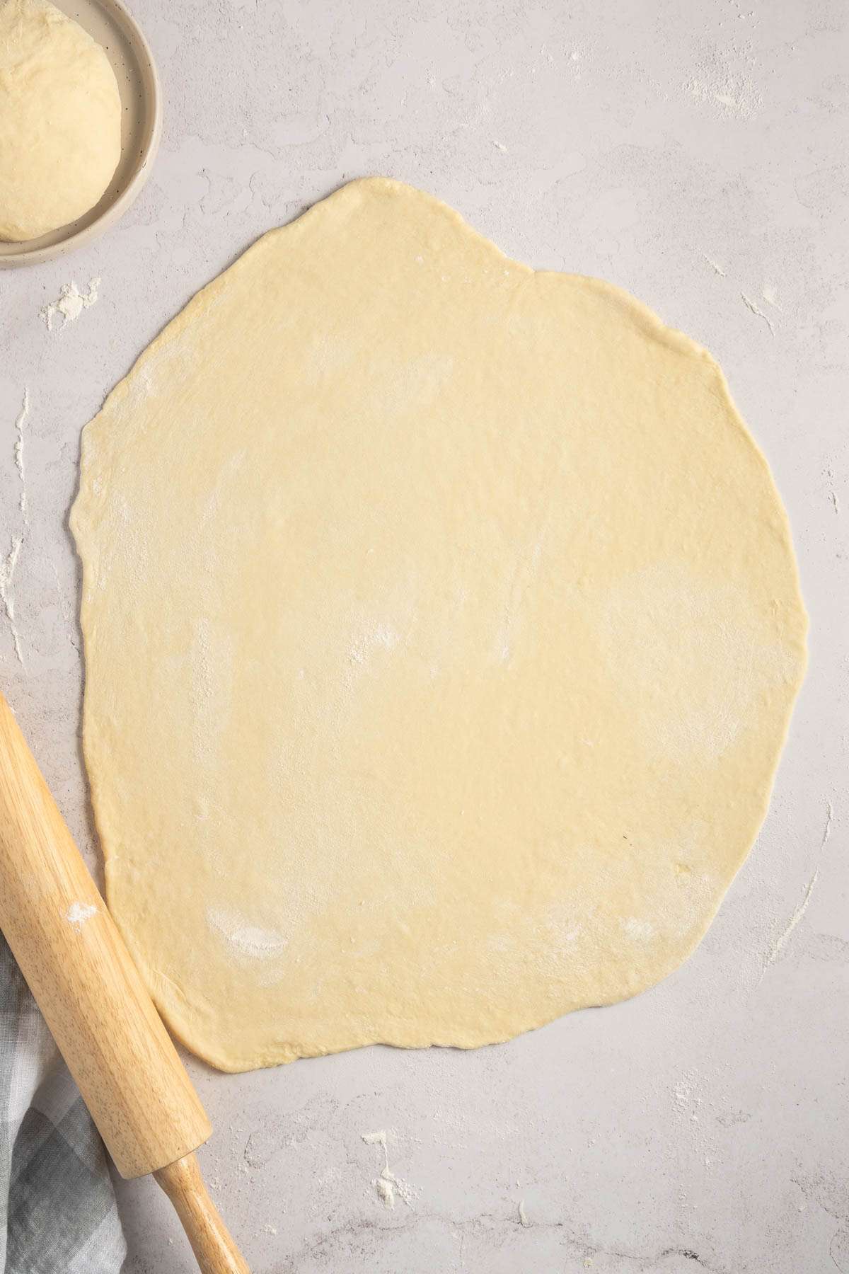 pierogi dough rolled out on a flat surface