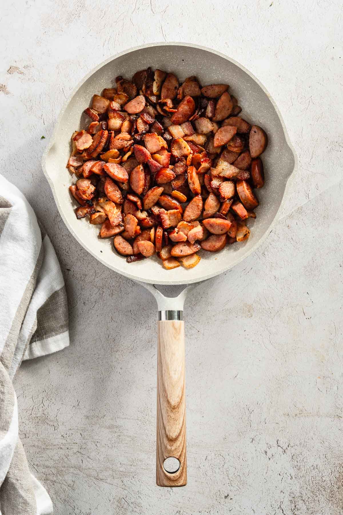 sausage and bacon on a frying pan, after cooking