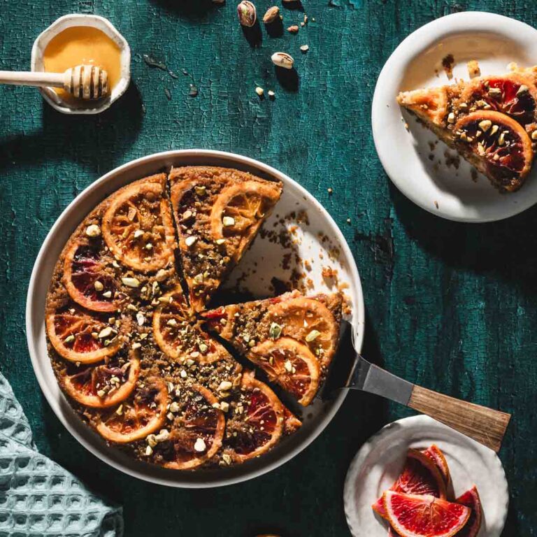 finished blood orange cake, slice on a plate, serving spatula