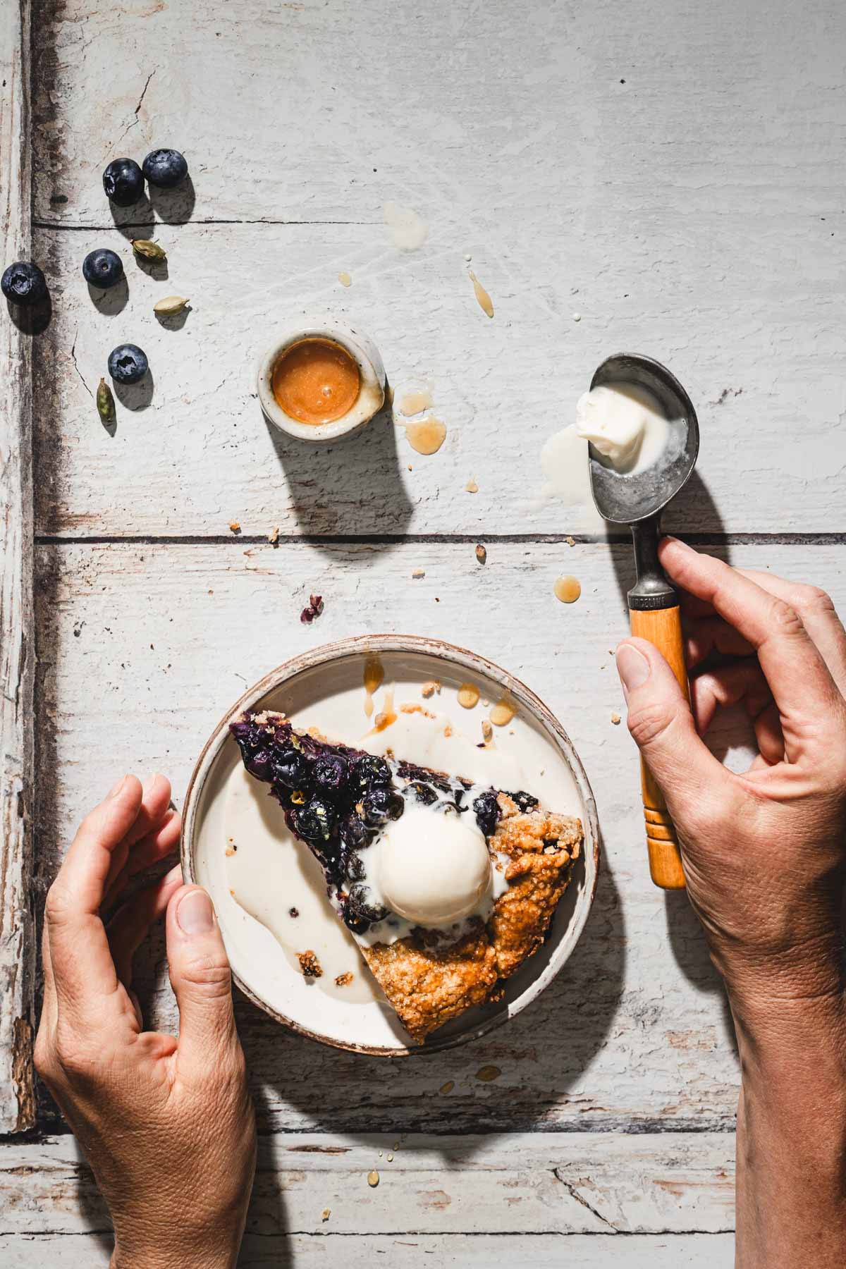 hands in frame holding ice cream scoop