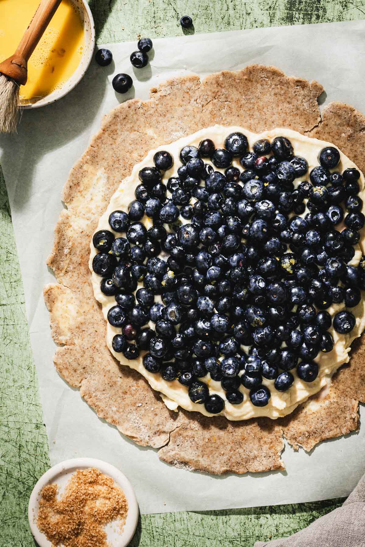 crust with filling and blueberries added