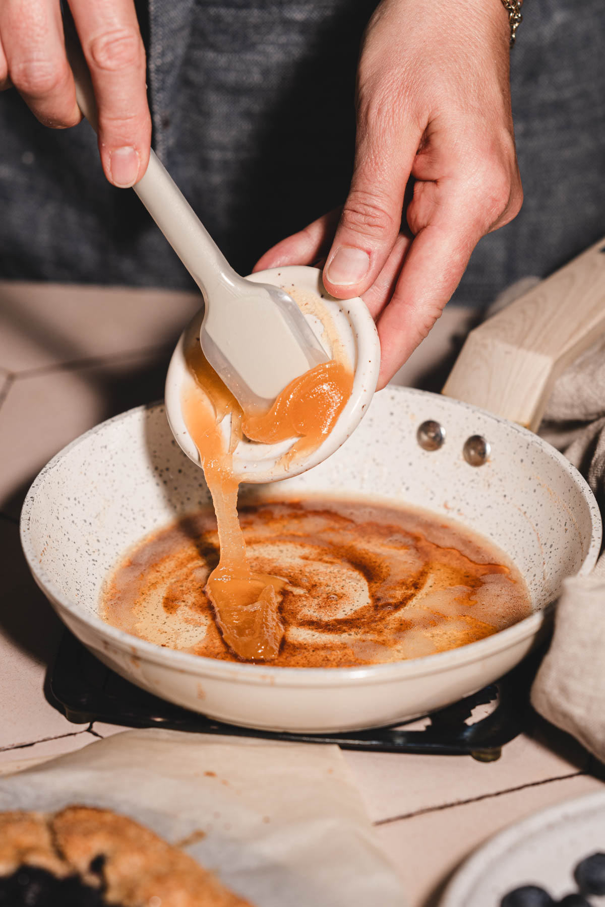 hands in frame holding dish with honey