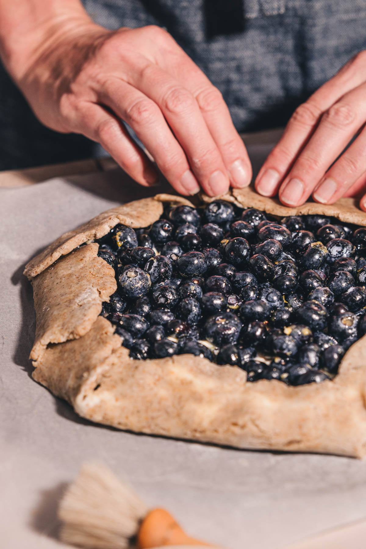 hands in frame folding edges of the crust
