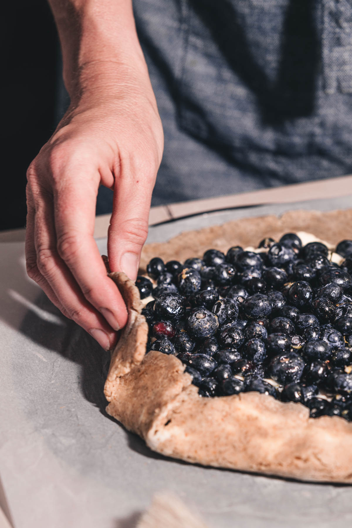 hands in frame folding edges of the crust