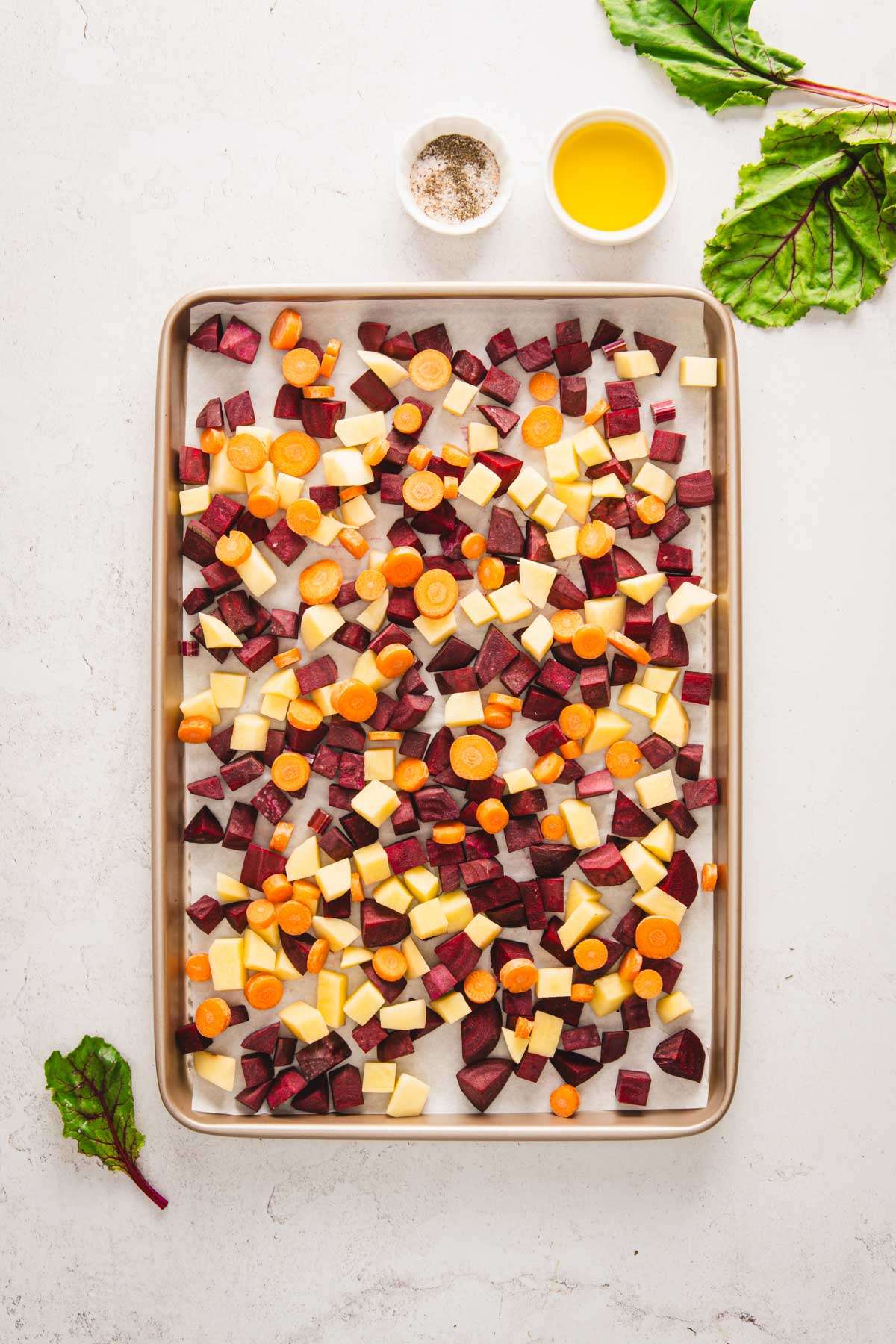 baking sheet with fresh, cut up veggies, dish with oil, SP