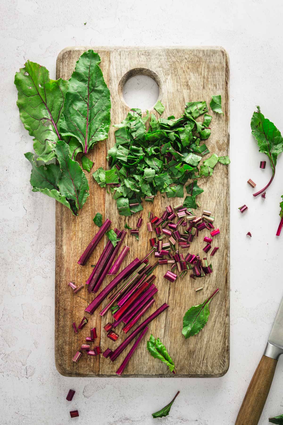 beet stems chopped on a wooden board