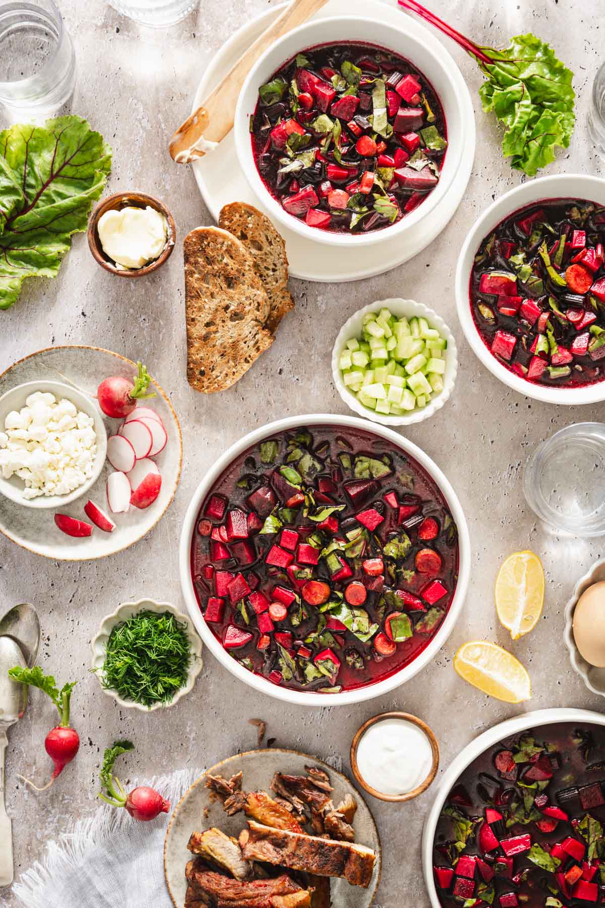 on a light background, botwinka soup dish with eggs, radishes, feta cheese, sliced bread