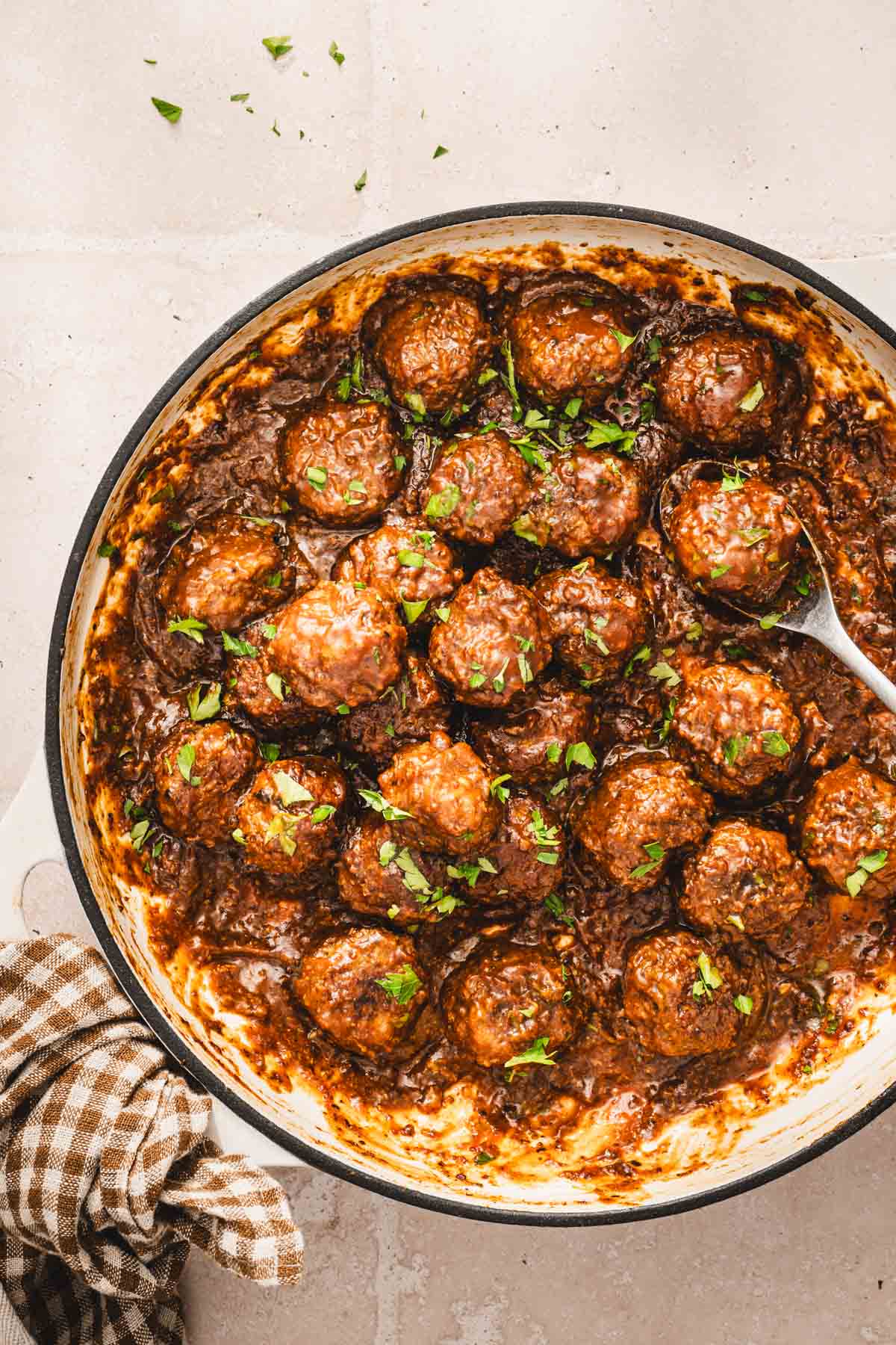 large skillet with cooked meatballs