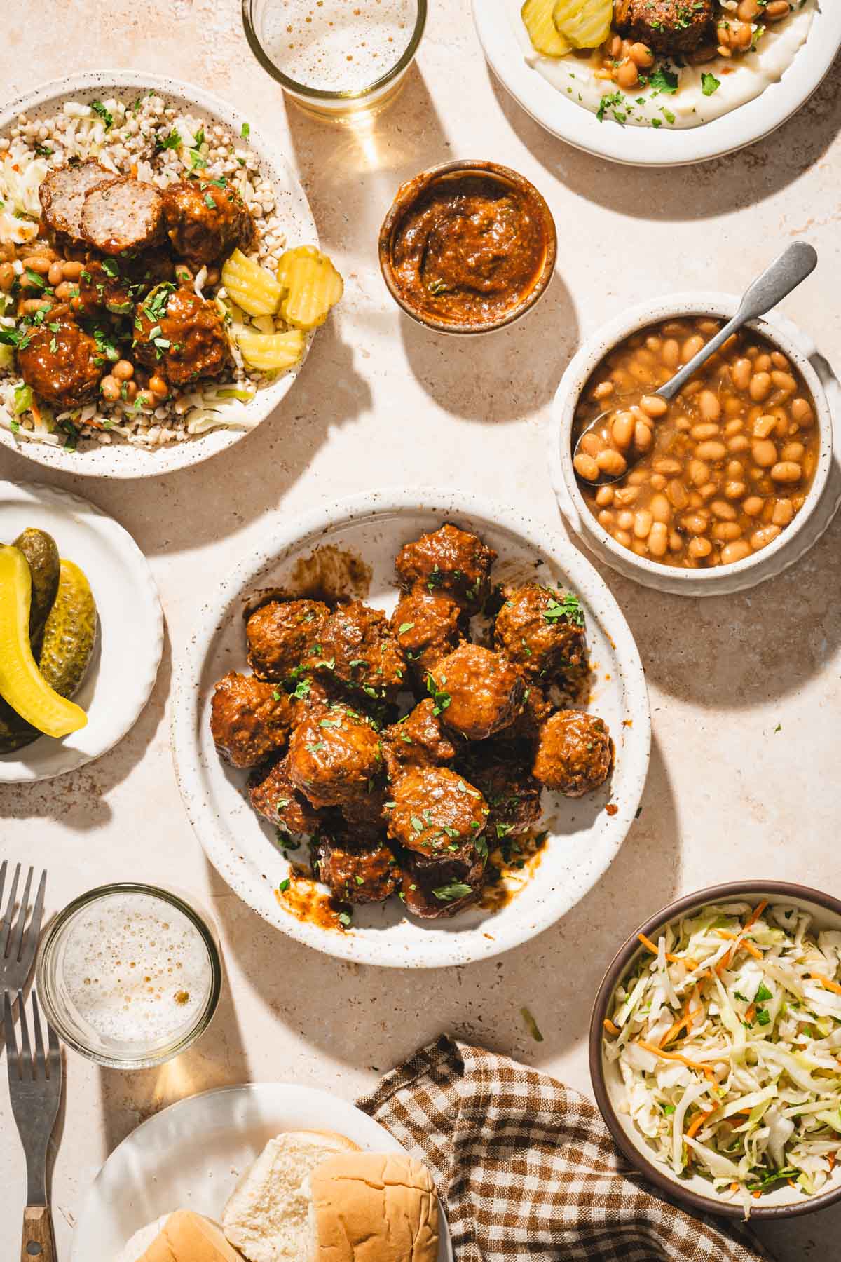 serving plate with meatballs, beans, pickles, dish with salad