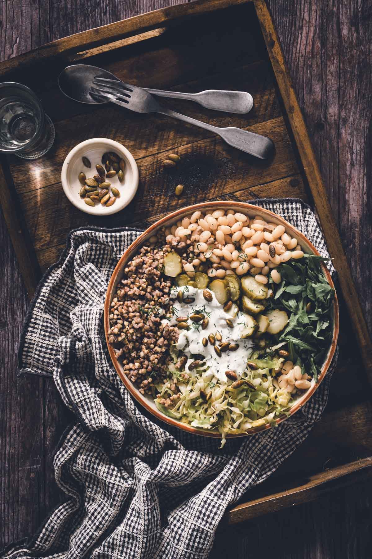 buckwheat bean bowl in a serving bowl on a wooden serving tray