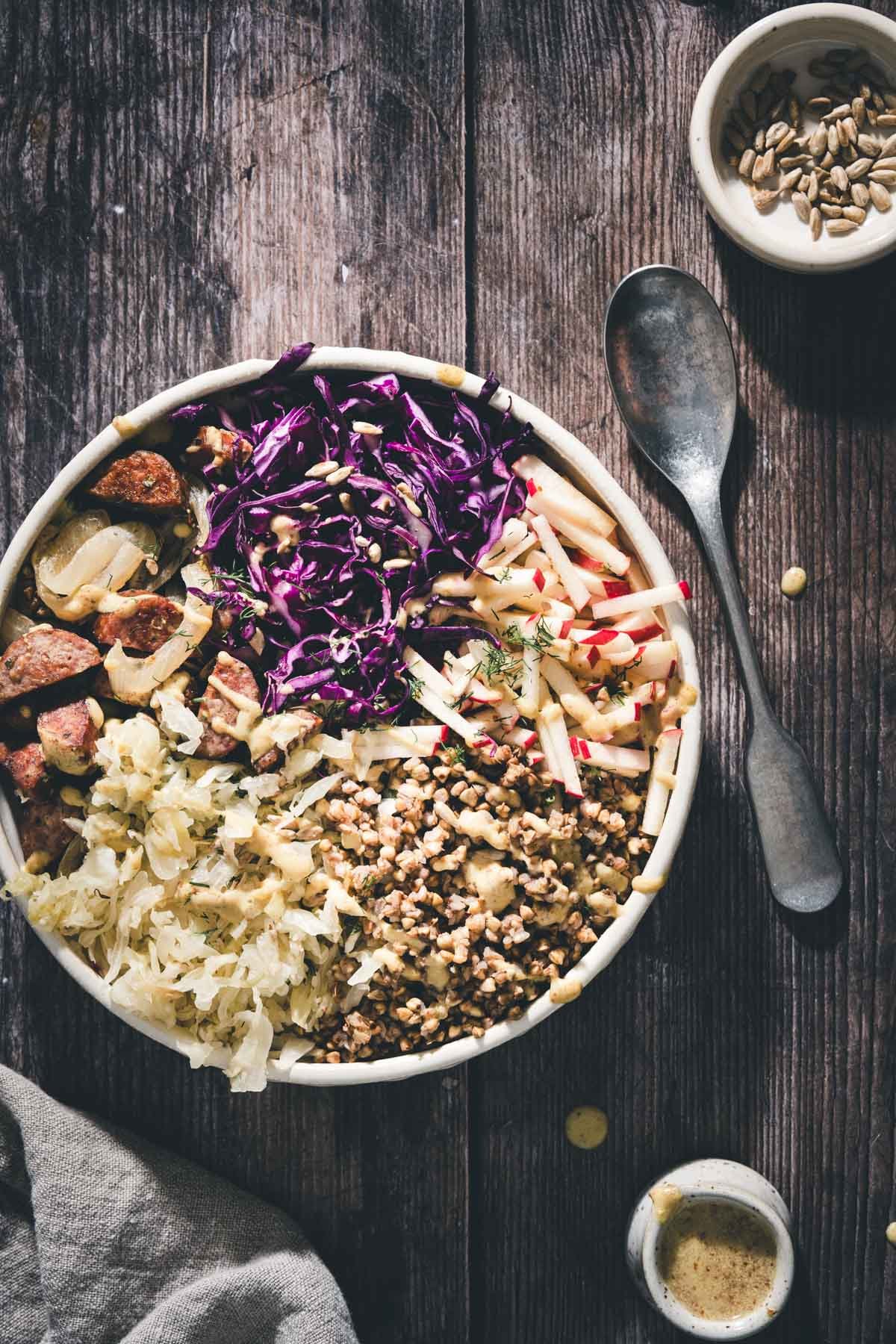 a buckwheat bowl, dish with dressing, spoon