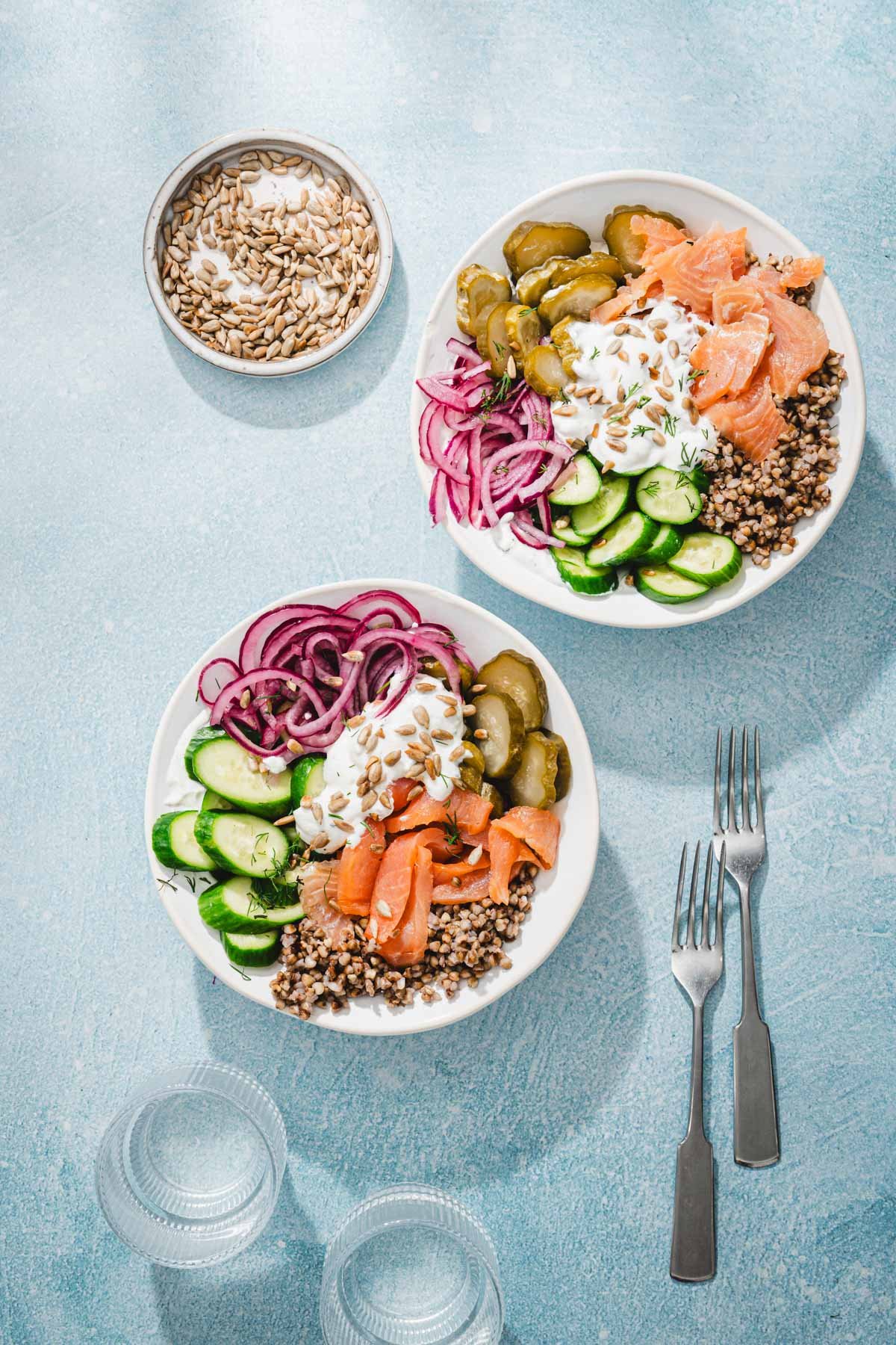 serving bowls with salmon, buckwheat and veggies