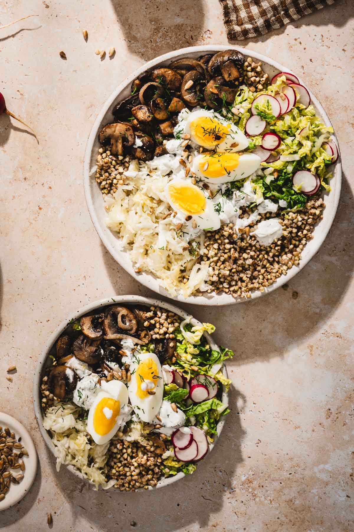 two serving bowls with mushroom and buckwheat