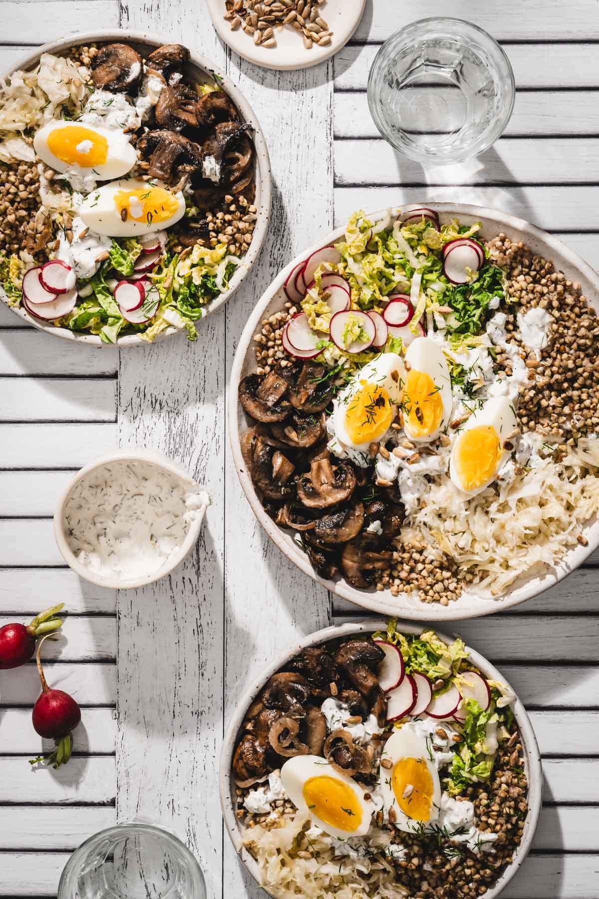 top view of serving bowls with mushroom and buckwheat; dish with the dressing