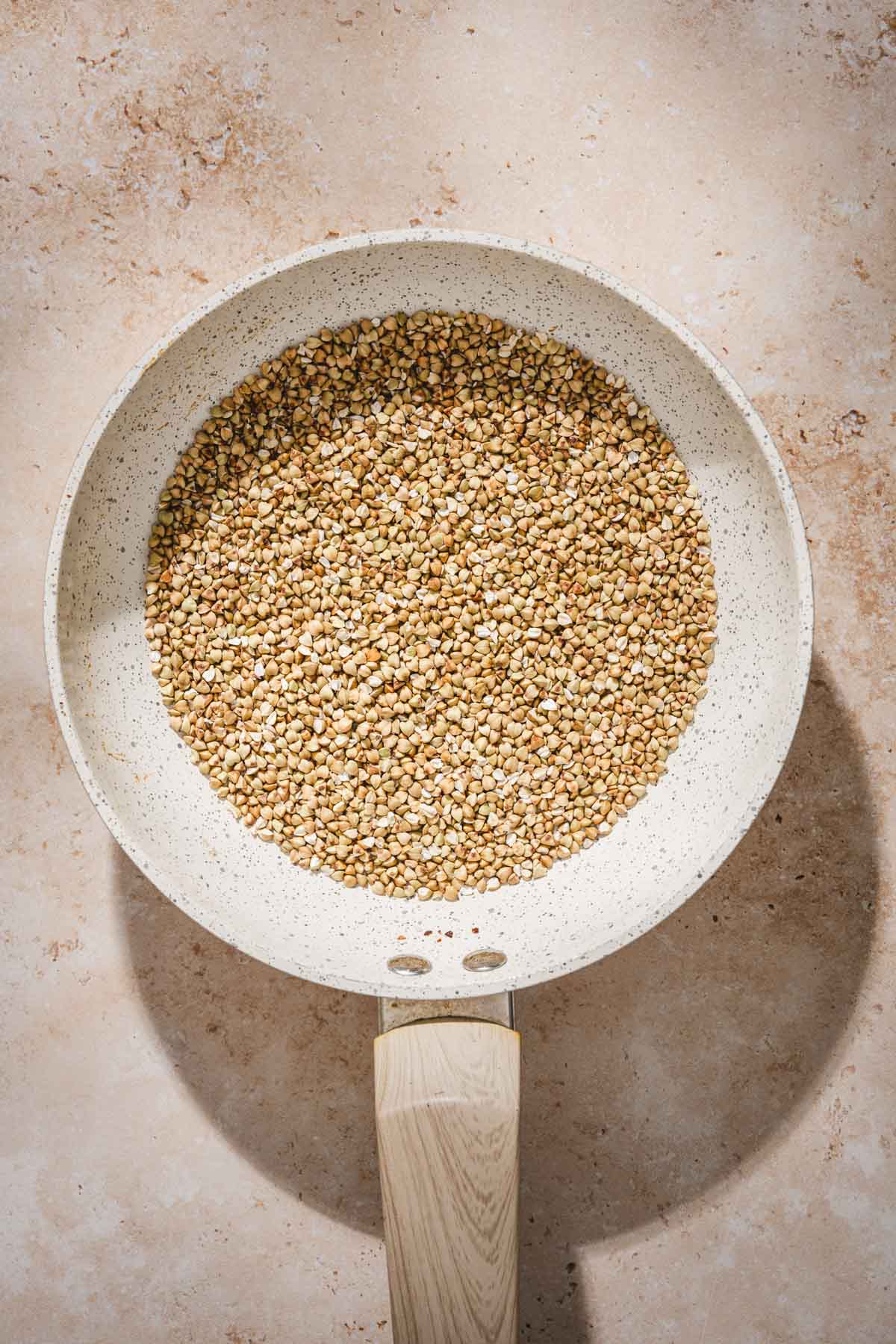 raw buckwheat groats on a skillet