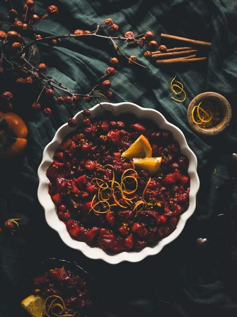 CRANBERRY AND PERSIMMON SAUCE IN A WHITE BOWL ON A TABLE