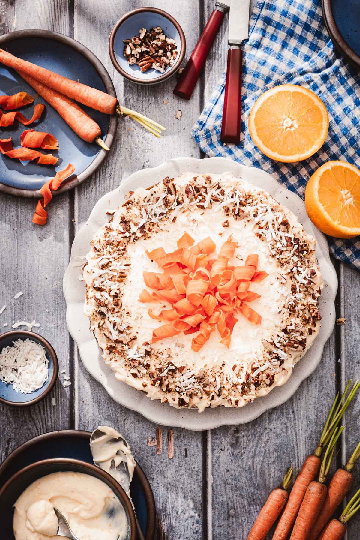 cake decorated with nuts and coconut and carrot ribbons