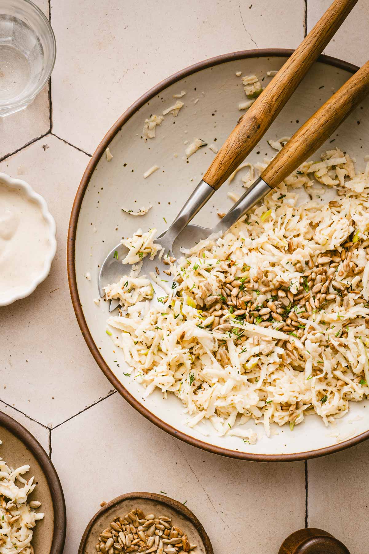 finished salad in a serving bowl, srving utensils