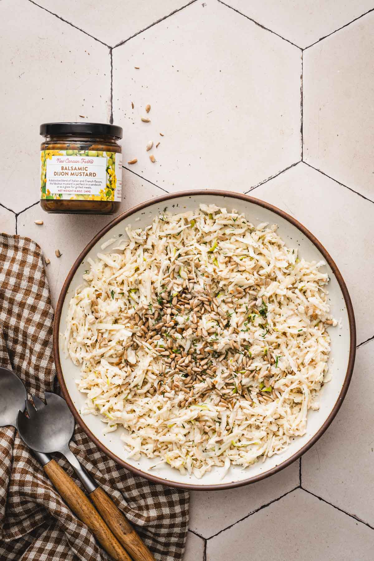 finished salad in a serving bowl, jar of Balsamic Dijon Mustard