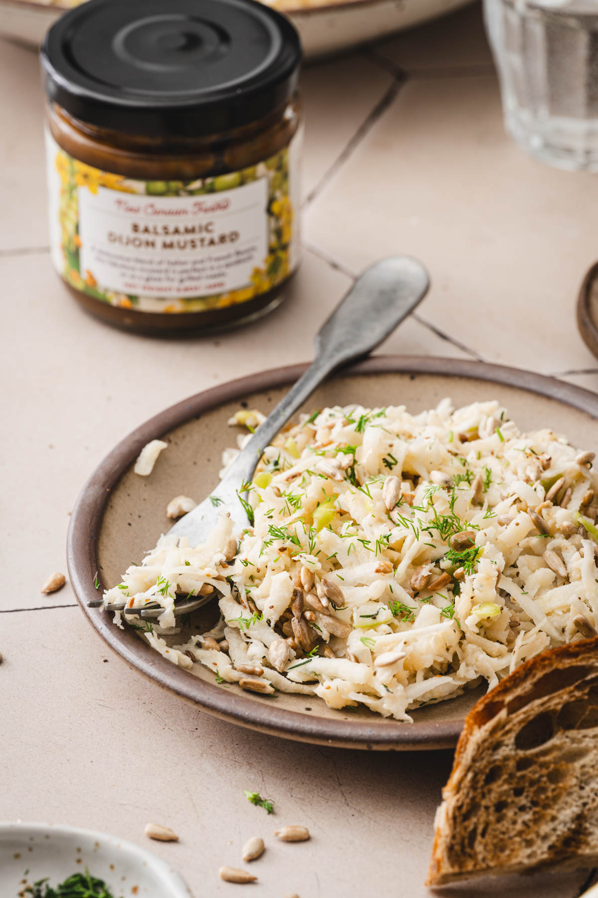 side view of the plate with slaad, jar with mustard