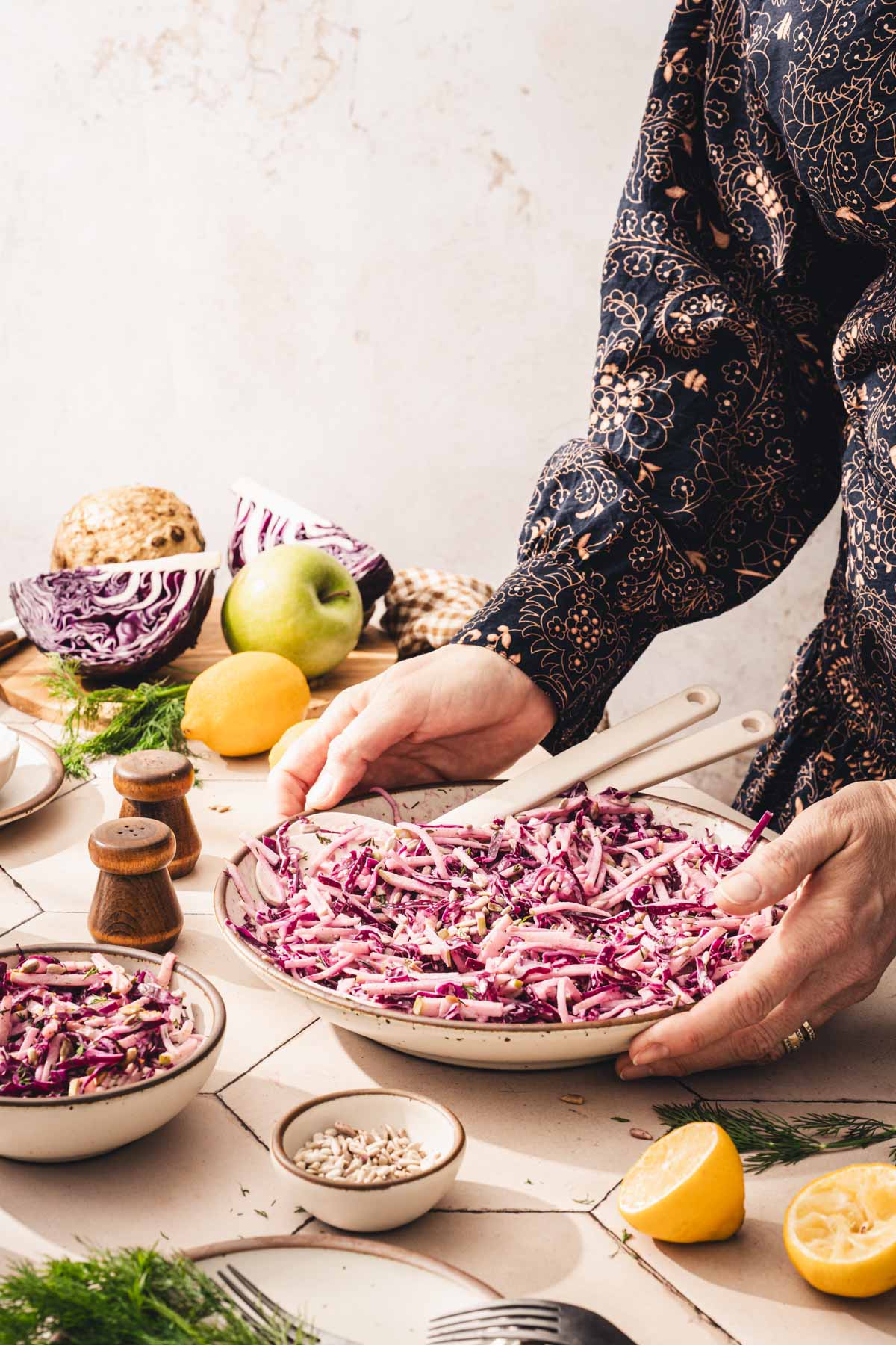 hands in fram holding the bowl with salad