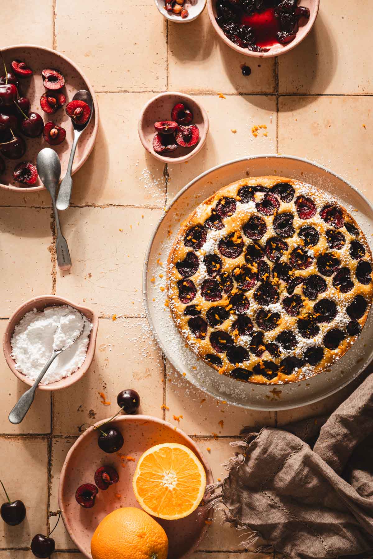 cherry biszkopt on a serving platter, fresh cherries, sliced orange
