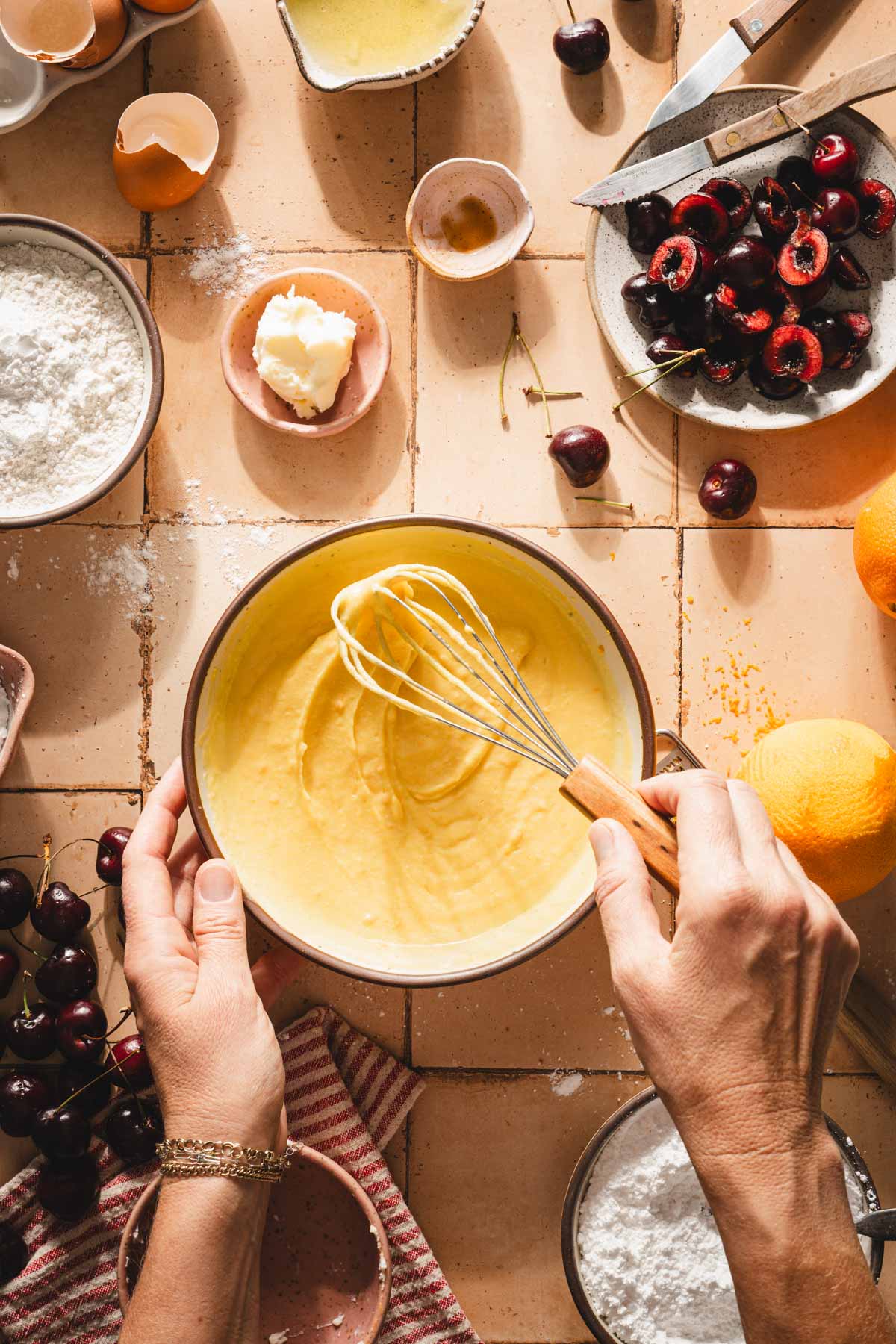 hands in frame holding whisk