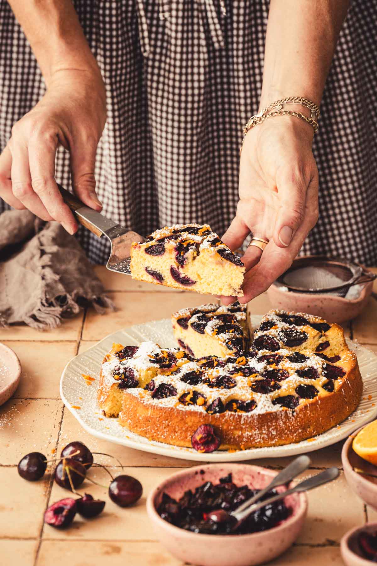 hands in frame holding spatula with a slice of cake
